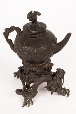 Lot 1038 - A Japanese bronze teapot on stand, decorated...