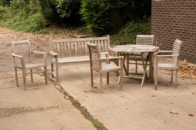 Lot 1103 - A teak slatted folding garden table, 100cm...