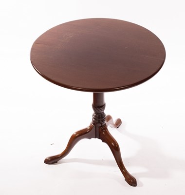 Lot 1128 - A circular mahogany table on a turned column...