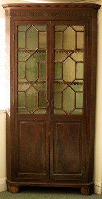 Lot 1138 - A George III two-tier mahogany corner cupboard...