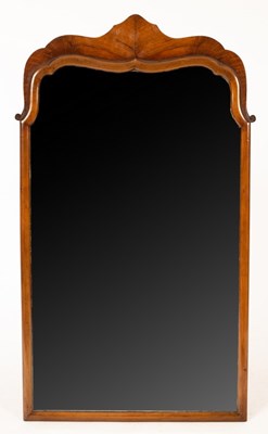 Lot 1152 - A mahogany arch-top mirror, the glass plate...