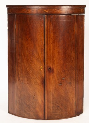 Lot 1161 - A 19th Century bowfront mahogany hanging...