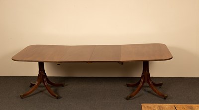 Lot 1163 - A mahogany dining table raised on twin...