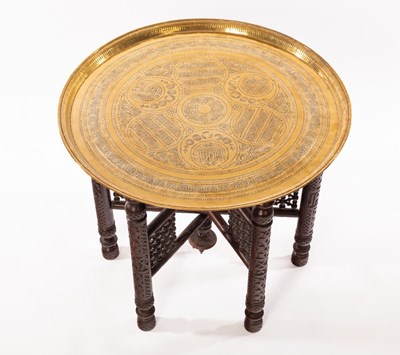 Lot 1188 - A brass topped Benares table, the round tray...