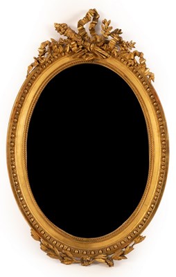 Lot 1206 - An oval gilt framed mirror surmounted by a...