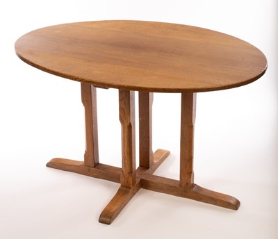 Lot 1218 - An oval oak table, on square chamfered legs to...