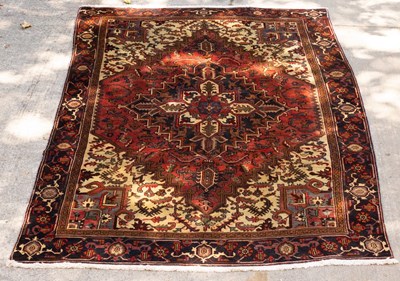 Lot 1253 - A Persian rug of red and ivory ground with...