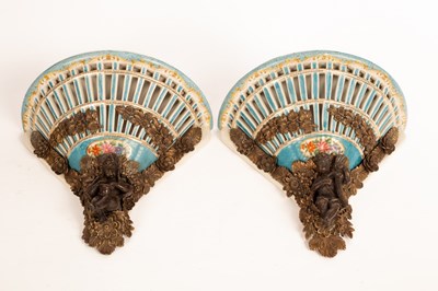 Lot 1311 - A pair of porcelain wall brackets with gilt...