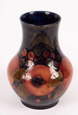 Lot 1315 - A Moorcroft vase decorated pomegranates on a...