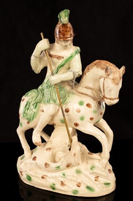 Lot 1349 - A Staffordshire creamware group of St George...