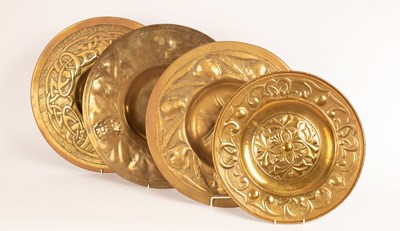 Lot 1370 - Four embossed brass chargers, the largest 46cm...