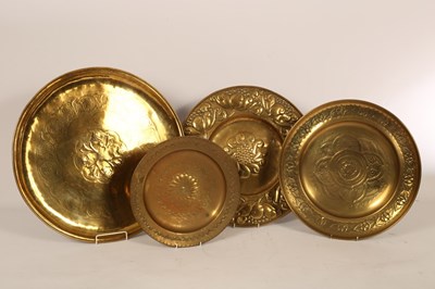 Lot 1372 - Four embossed brass chargers of floral motif,...