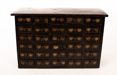 Lot 1408 - A miniature ebonised bank of drawers, five...