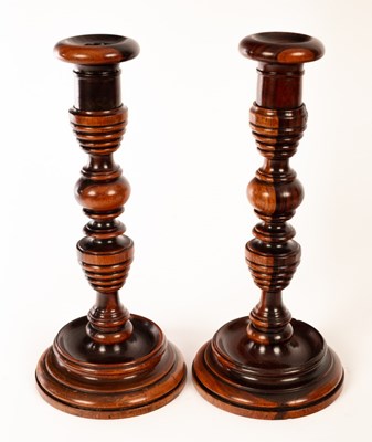 Lot 1410 - A pair of turned lignum vitae candlesticks, 31....