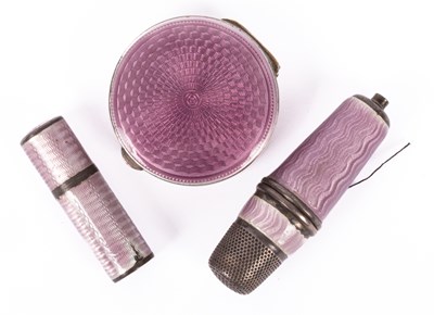 Lot 141 - A silver and purple enamel circular compact