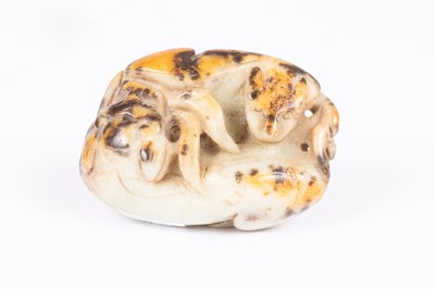Lot 24 - A Chinese pebble jade carving of entwined beasts