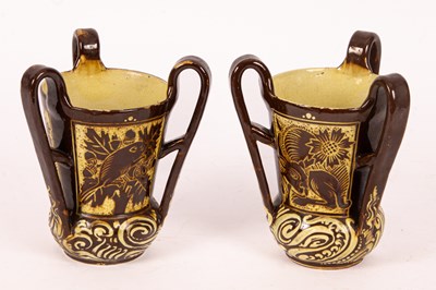 Lot 277 - A pair of CH Brannam Barum Arts and Crafts brown ground tygs