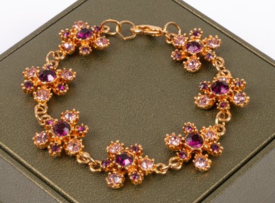 Lot 71 - A costume jewellery yellow metal and amethyst coloured stone mounted bracelet