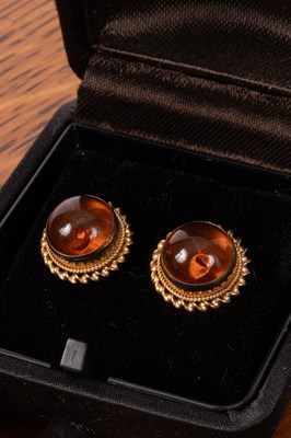 Lot 82 - A pair of 9ct gold and reconstituted amber stud earrings