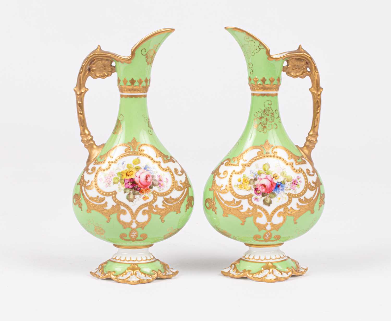 Lot 239 - A pair of Royal Crown Derby small ewers