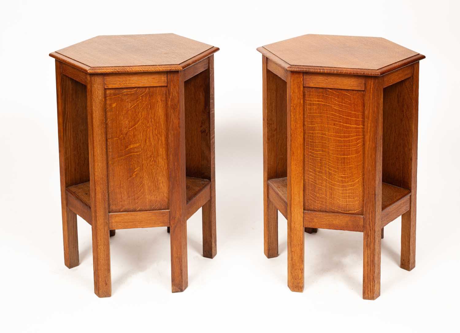 Lot 431 - A pair of Arts & Crafts oak hexagonal bedside tables