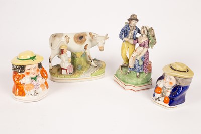 Lot 153 - A Staffordshire figure of a cow and milkmaid