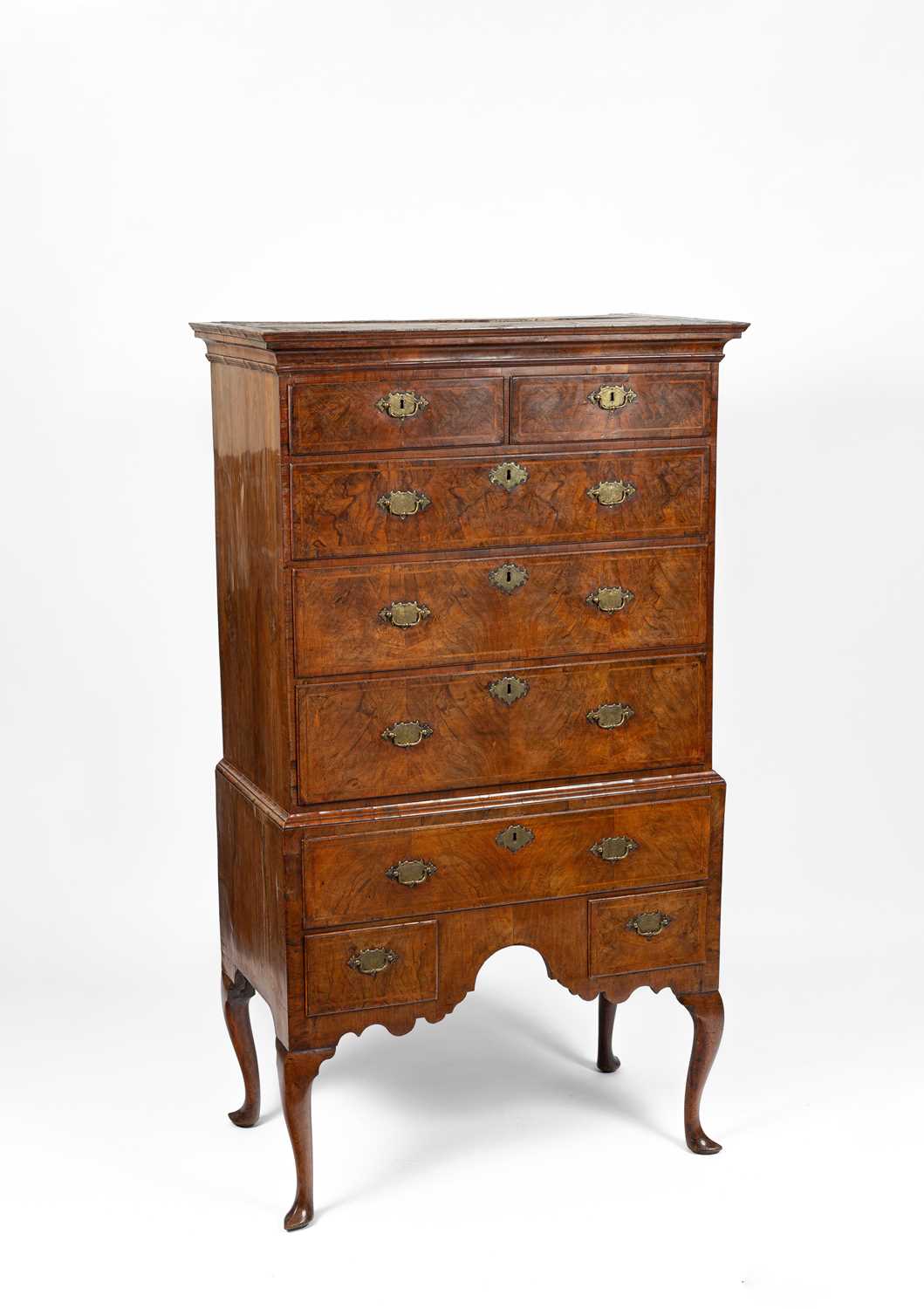 Lot 177 - A Queen Anne figured walnut chest on stand