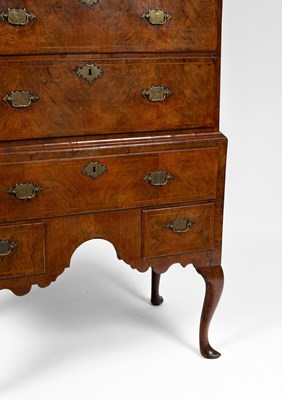 Lot 177 - A Queen Anne figured walnut chest on stand