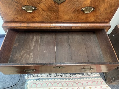 Lot 621 - A Queen Anne figured walnut chest on stand