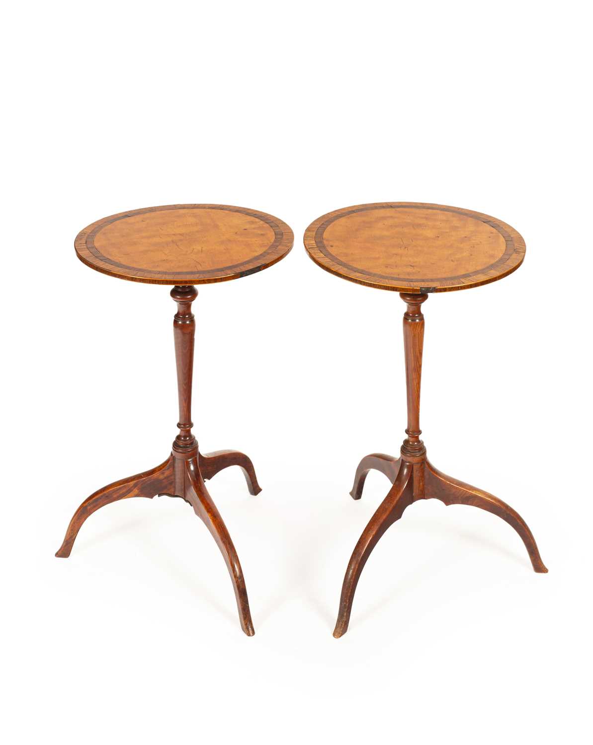 Lot 56 - A pair of late George III satinwood tripod tables