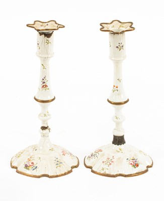 Lot 91 - A pair of South Staffordshire white enamel candlesticks