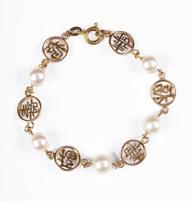 Lot 228 - A 14k gold and Mikimoto pearl bracelet