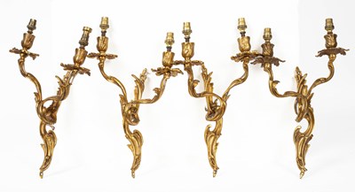 Lot 599 - A set of four Rococo style two branch wall lights