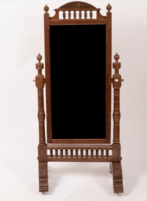 Lot 577 - An Arts & Crafts style grained mahogany cheval mirror