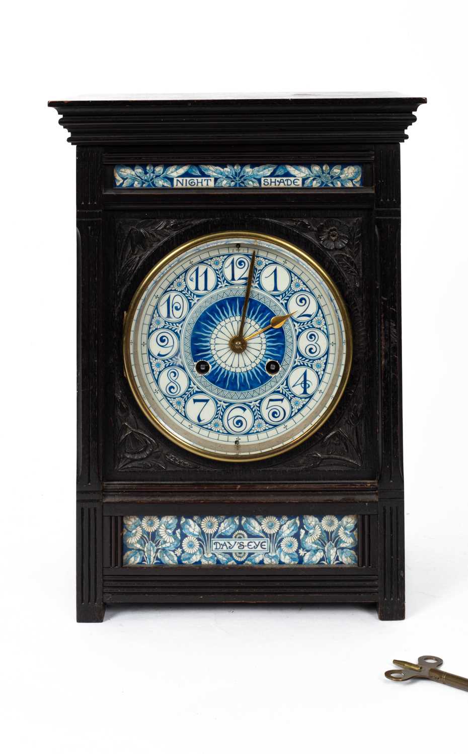 Lot 12 - Lewis Foreman Day (1845-1910) An Arts and Crafts porcelain mounted ebonised mantel clock