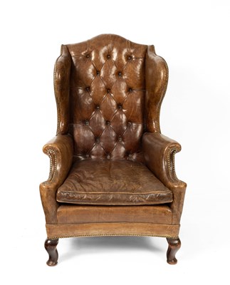 Lot 636 - An early 20th Century leather wingback chair