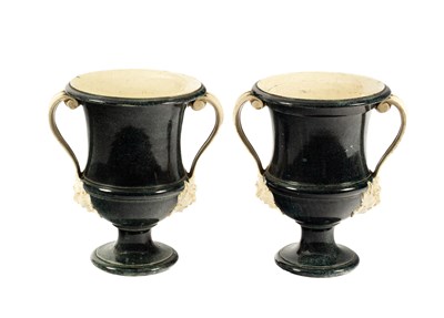 Lot 210 - A pair of creamware 'porphyry' two-handled campana shaped urns