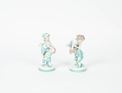 Lot 772 - A pair of Continental porcelain figures of children playing leap frog