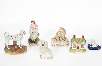 Lot 795 - Four Staffordshire figures of dogs