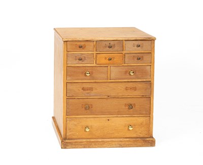 Lot 656 - A pine bank of eleven drawers