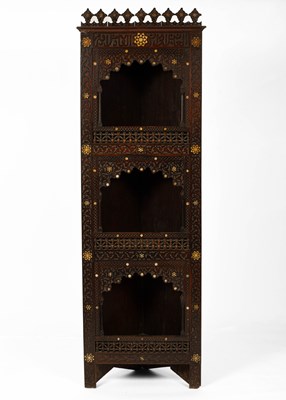 Lot 669 - A North African carved corner cupboard