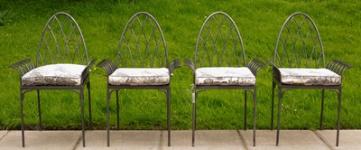Lot 557 - A set of four iron garden chairs of Gothic style