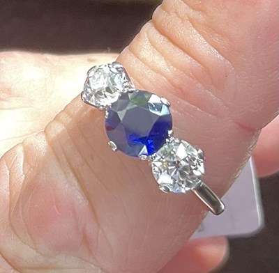 Lot 298 - A sapphire and diamond three-stone ring