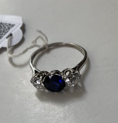 Lot 298 - A sapphire and diamond three-stone ring