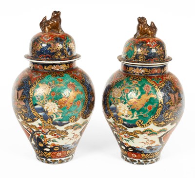 Lot 591 - A pair of Japanese Imari vases and covers