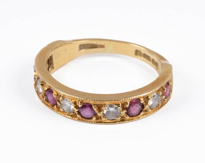 Lot 384 - An 18ct yellow gold ruby and diamond half eternity ring