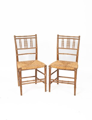 Lot 547 - A pair of faux bamboo carved chairs