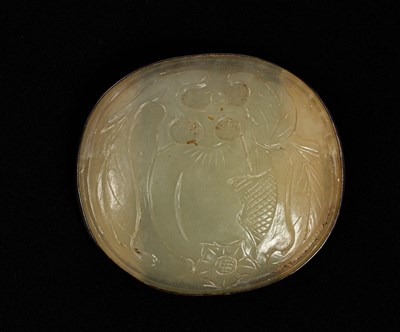 Lot 593 - A carved oval jade plaque