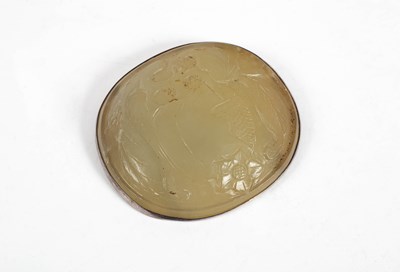 Lot 593 - A carved oval jade plaque