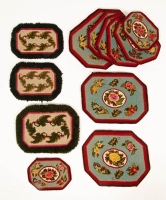 Lot 666 - A set of nine graduating needlework table mats